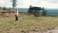 TOMSK, RUSSIA - May 23, 2020: DJI Mavic Pro drone hovering in the air and girl on background