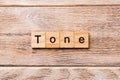 Tone word written on wood block. tone text on wooden table for your desing, concept