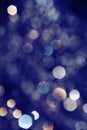 Toned in blue bokeh lights on black background, drops of water flying in the air defocused Royalty Free Stock Photo