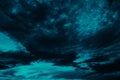 Toned blue green night sky with clouds. Dark teal sky background with copy space