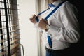 Toned closeup of businessman adjusting suspenders at office