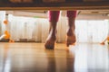Toned closeup image of young barefoot girl in pajamas standing on wooden floor in bedroom Royalty Free Stock Photo