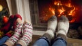 Toned closeup image of family warming feet at fireplace at night Royalty Free Stock Photo
