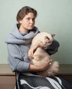 Toned closeup photo of woman with a cat in her arms