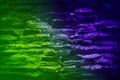 Toned green purple blue stone brick old wall. Close-up. Neon or electric light effect. Background. Royalty Free Stock Photo