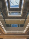 Toned image of beautiful atrium with glass and wooden balconies at modern business building