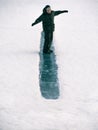 Toned image child to ride on an ice hill standing on their feet