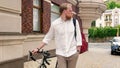 Toned image of handsome bearded man walking with bicycle on street Royalty Free Stock Photo