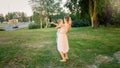 Toned image of happy smiling young mother holding and embracing her toddler son at park Royalty Free Stock Photo