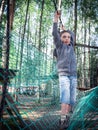 Toned image little boy with a strained face goes on a rope