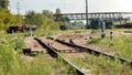 Toned image of old industrial railroad at the cargo hub with trains, wagons and containers