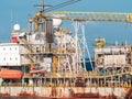 Toned image of old rusty container cargo ship or oil tanker in docks Royalty Free Stock Photo