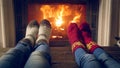 Toned photo of romantic family wearing knitted woolen socks warming at fireplace Royalty Free Stock Photo