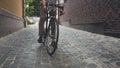 Toned image of stylish young man riding vintage bicycle on paved road Royalty Free Stock Photo