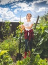 Toned image of teenage girl working on garden at farm