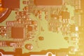 A toned macro image of a computer board with many small technological elements. Extremely shallow depth of field. Abstract techno