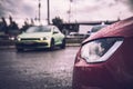 Toned with magenta image The front of a red sports tuned car with lowered suspension. Against the background of another sports car Royalty Free Stock Photo