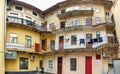 Toned panoramic image of inner court and facade of old living building at small european town Royalty Free Stock Photo