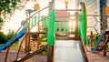 Toned image of big wooden playground with lots of ladders and slides at park