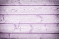 Toned photo of a fence made of wooden boards. Light Lilac background for layouts and sites Royalty Free Stock Photo