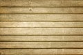 Toned photo of a fence made of wooden horizontal boards. Dirty brown background, for layouts and sites Royalty Free Stock Photo