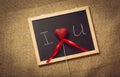 Toned photo of heart in declaration of love on blackboard