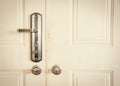 Toned photo metal entrance door with rustic keyed entry door handle at apartment in Hanoi, standard door handle with knob lock Royalty Free Stock Photo