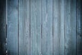 Toned photo of an old fence made of nailed boards. Dark blue background for sites and layouts with vignette Royalty Free Stock Photo