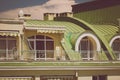 Toned photo of terrace under green metal roof at classic building Royalty Free Stock Photo