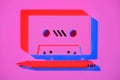 toned pink picture of retro audio cassette and pencil