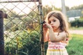 Toned portrait of a Cute little girl looking sad standing near t