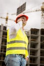 Toned portrait of construction engineer talking by phone on cons Royalty Free Stock Photo