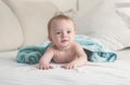 Toned portrait of cute baby boy with wet hair lying on bed after having bath Royalty Free Stock Photo