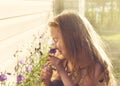 Toned portrait of girl holding flowers in the summer morning Royalty Free Stock Photo