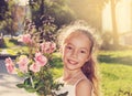Toned portrait of happy beautyful little Girl hold roses and smile at summer day Royalty Free Stock Photo