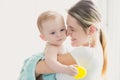 Toned portrait of happy smiling mother holding her baby after ba Royalty Free Stock Photo