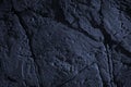 Toned rock texture. Cracked stone surface. Close-up. Dark blue rough background with copy space Royalty Free Stock Photo