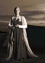 Toned vertical portrait in full length of a young woman in historical costume Royalty Free Stock Photo