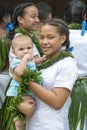 Tonga, school girl with baby on arm