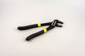 Tongue-and-groove slip-joint pliers detail with movable jaw on a white background