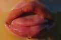 Tongue and lips of a young girl. Sweet honey on the lips. Dessert and sweet life. A delicious kiss. Oral caresses Royalty Free Stock Photo