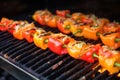 tongues of flame licking chopped bell peppers on the grill