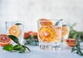 Tonic nonalcoholic mocktail with red Sicilian oranges and ice, grey background. Cold refreshing summer mojito lemonade Royalty Free Stock Photo