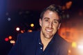 Tonight is my night. Portrait of a happy young man posing alone on the balcony of a nightclub. Royalty Free Stock Photo