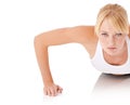 Toning through body weight exercises. Closeup portrait of a young woman doing push-ups against a white background. Royalty Free Stock Photo