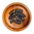 Tonka beans, also tonkin beans or tonquin beans, in a wooden bowl Royalty Free Stock Photo