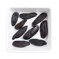 Tonka beans, Tonkin or Tonquin beans, in a white bowl Royalty Free Stock Photo