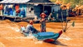 Cambodian people live on Tonle Sap Lake in Siem Reap, Cambodia. Woman and child rowing rowing boat