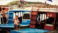 Cambodian people live on Tonle Sap Lake in Siem Reap, Cambodia. Woman riding on a motorboat