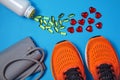 Tonometer for measuring blood pressure, orange sneakers and a jar of capsules of polyunsaturated fatty acids and hearts